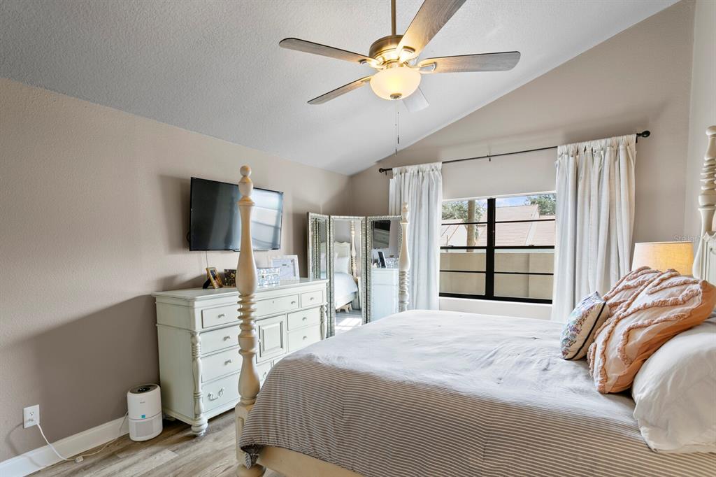 6712 Jennifer Drive Temple Terrace, FL 33617 - Photo 17 of 30 a bedroom with a bed and a flat screen tv