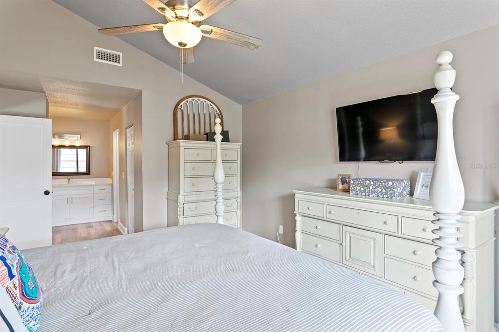 6712 Jennifer Drive Temple Terrace, FL 33617 - Photo 18 of 30 a bedroom with a bed and a flat screen tv