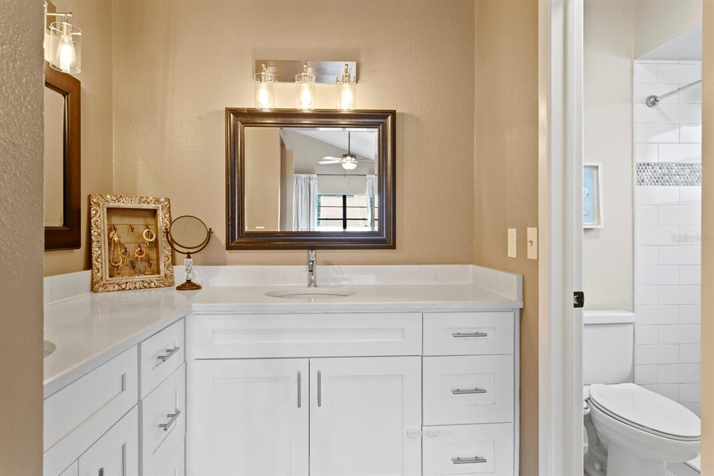 6712 Jennifer Drive Temple Terrace, FL 33617 - Photo 19 of 30 a bathroom with a granite countertop sink vanity mirror and toilet