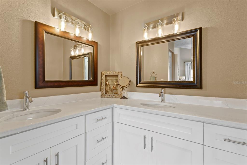 6712 Jennifer Drive Temple Terrace, FL 33617 - Photo 20 of 30 a bathroom with double vanity sinks and a mirror