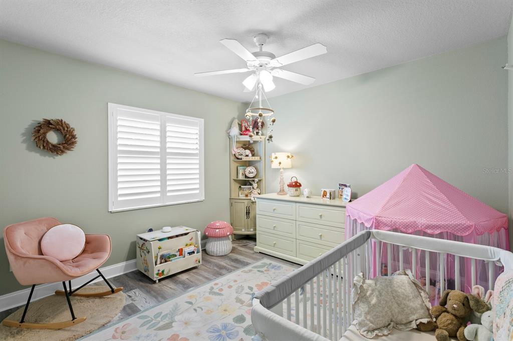 6712 Jennifer Drive Temple Terrace, FL 33617 - Photo 21 of 30 a bedroom with furniture and a window
