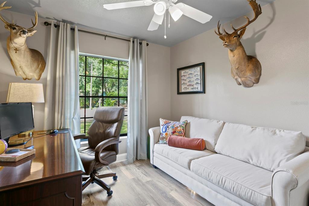 6712 Jennifer Drive Temple Terrace, FL 33617 - Photo 23 of 30 a living room with furniture a flat screen tv and a window