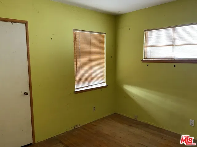 a view of a room with a window and wooden floor