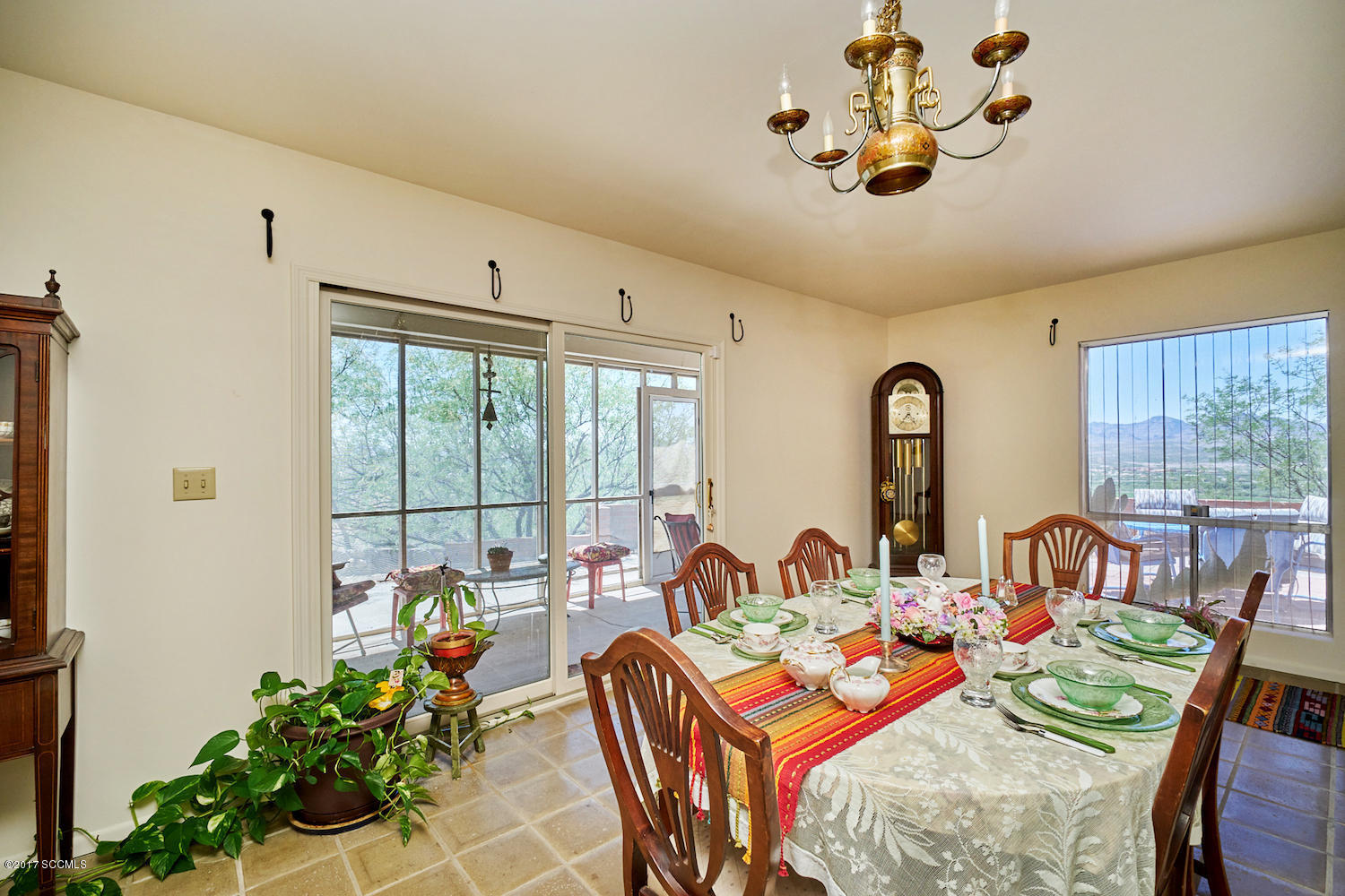 380 Rio Rico Drive Rio Rico, AZ 85648 - Photo 8 of 42 a view of a dining room with furniture a potted plant and a chandelier
