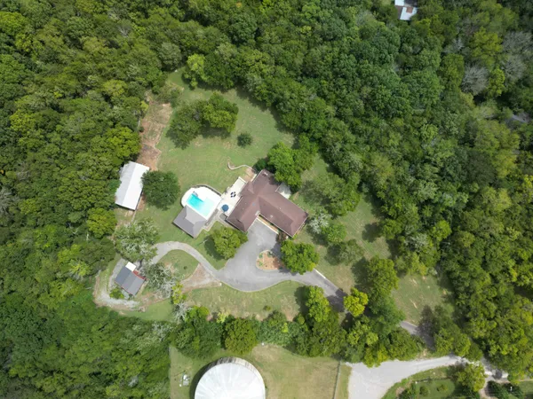a backyard of a house with a yard and outdoor seating