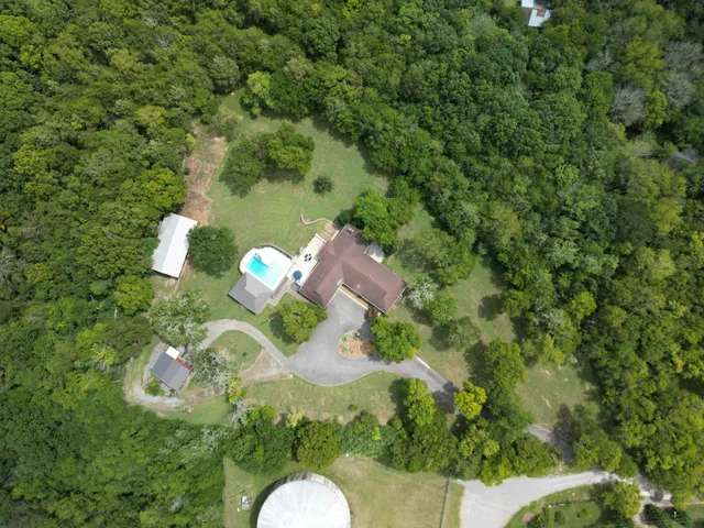 a backyard of a house with a yard and outdoor seating