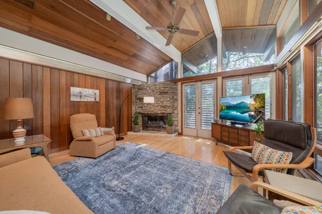 a living room with furniture a fireplace and a large window