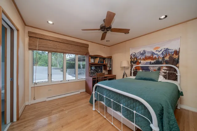 a bedroom with a large bed and a large window