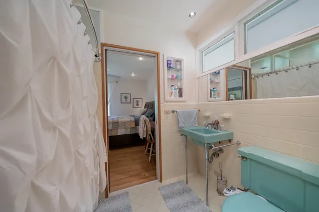 a bathroom with a toilet sink and mirror