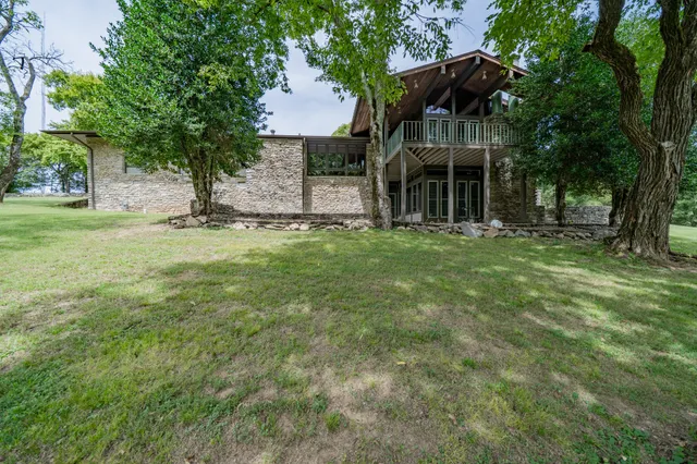 a patio with a table and chairs under an umbrella