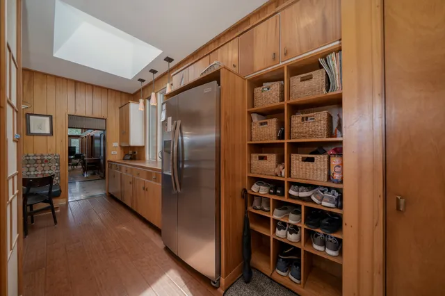 a kitchen with stainless steel appliances a refrigerator and a fireplace