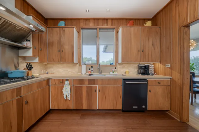 a kitchen with stainless steel appliances granite countertop a sink and a stove