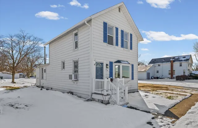 a view of a house with snow on the road