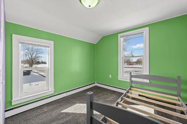 a room with pool table and paintings on the wall