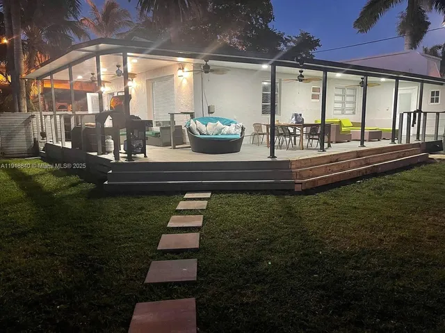 a view of a swimming pool with outdoor seating