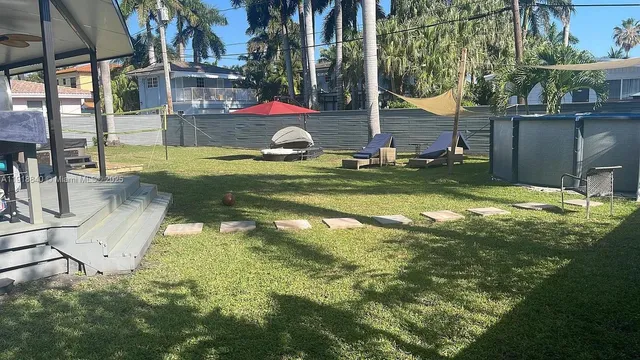 a view of swimming pool with a yard