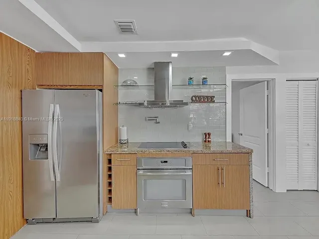 a kitchen with a sink stainless steel appliances and cabinets