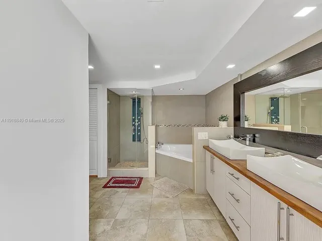 a bathroom with a sink a mirror and a bathtub