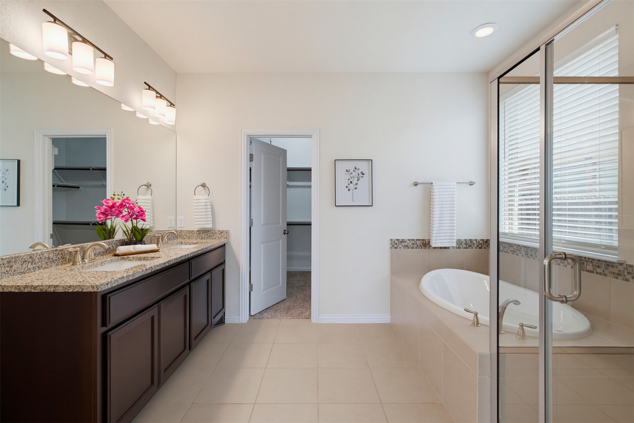 12613 Twisted Root Drive Manchaca, TX 78652 - Photo 12 of 33 Indulge in this well-appointed bathroom featuring a double vanity and a luxurious soaking tub.