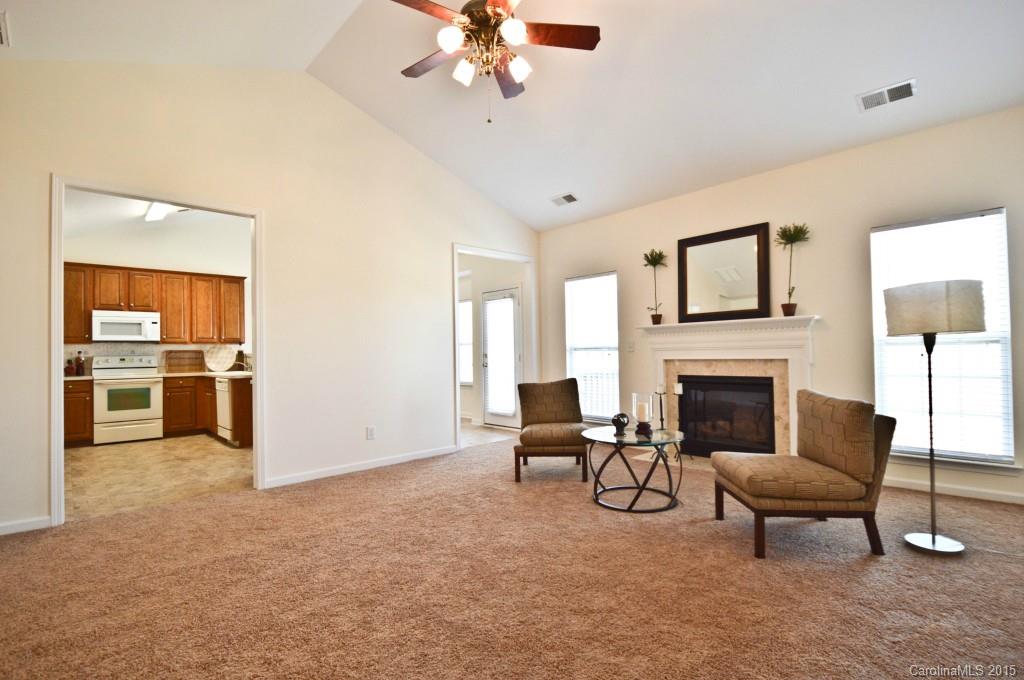 3740 Leela Palace Way Fort Mill, SC 29708 - Photo 3 of 11 a living room with furniture a fireplace and a chandelier