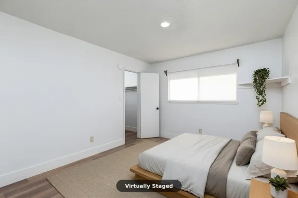 a bedroom with a bed and a potted plant