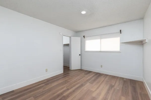 a view of a room with wooden floor