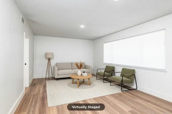 a dining room with furniture and wooden floor