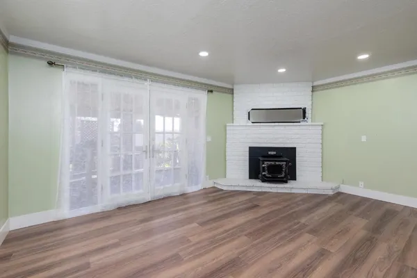 a kitchen with wooden floors and white cabinets