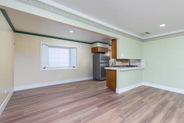 a kitchen with stainless steel appliances granite countertop a refrigerator and a stove top oven