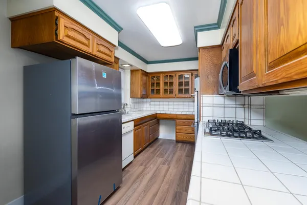 a kitchen with granite countertop stainless steel appliances sink and cabinets