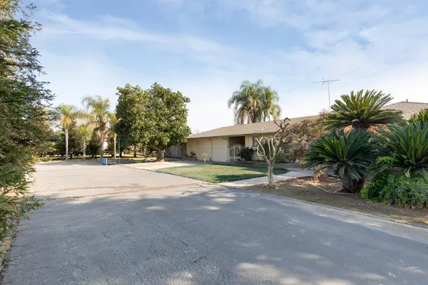 a view of a house with outdoor space and palm trees
