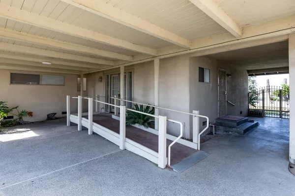 a view of a house with a wooden deck