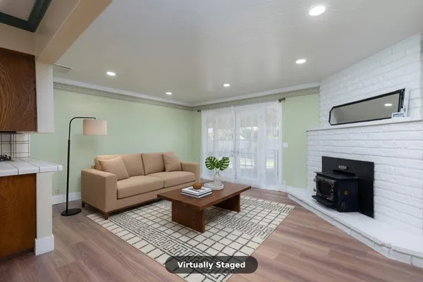 a view of empty room with wooden floor and fireplace