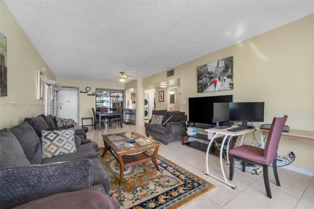 a living room with furniture a rug and a flat screen tv