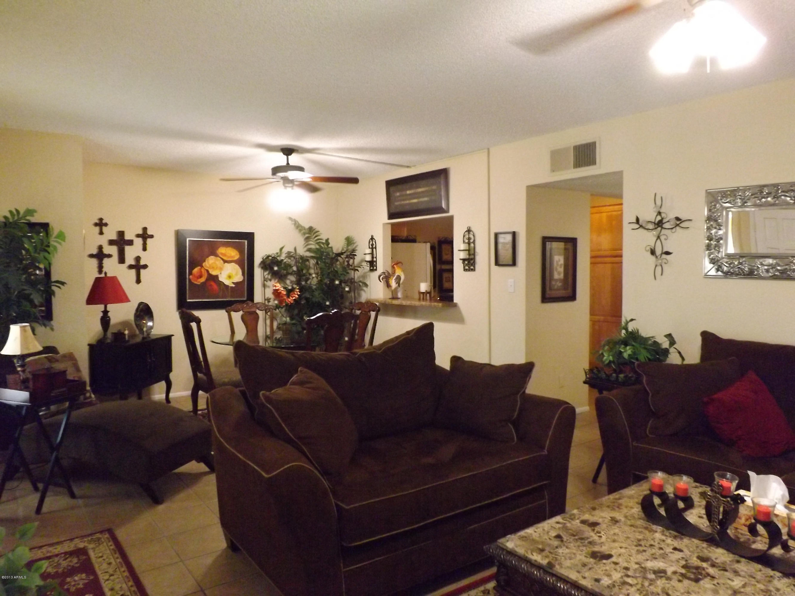240 Old Litchfield Road, Unit 207 Litchfield Park, AZ 85340 - Photo 2 of 9 a living room with furniture ceiling fan and a rug