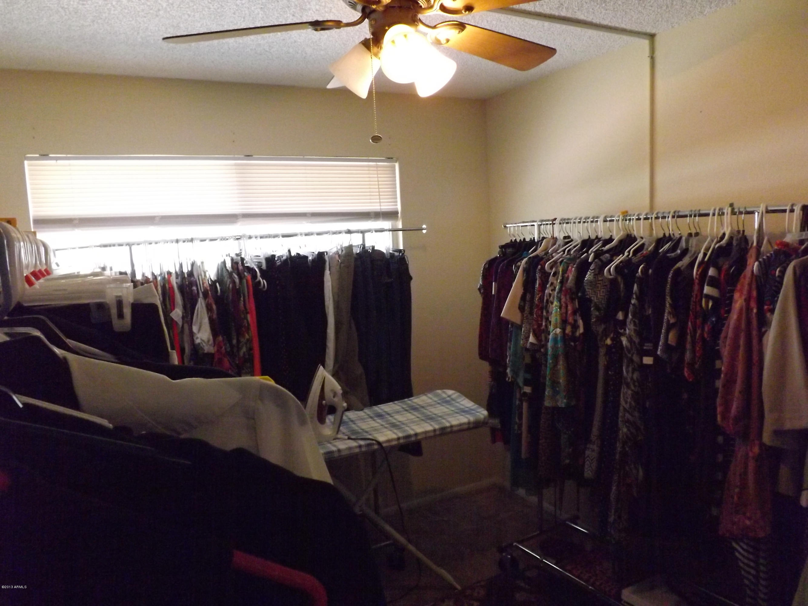 240 Old Litchfield Road, Unit 207 Litchfield Park, AZ 85340 - Photo 6 of 9 a view of walk in closet with clothes and shoes