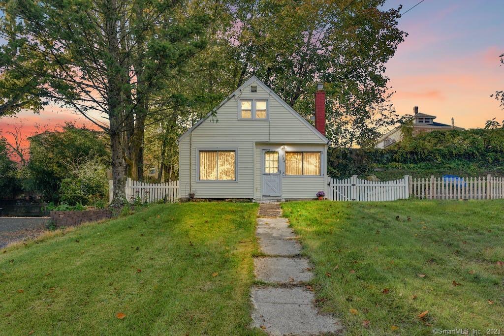 a front view of a house with yard and green space