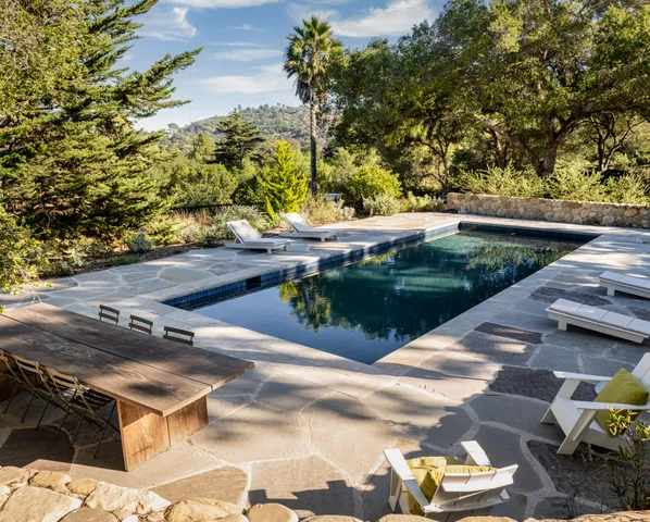 a view of swimming pool with a yard and sitting area