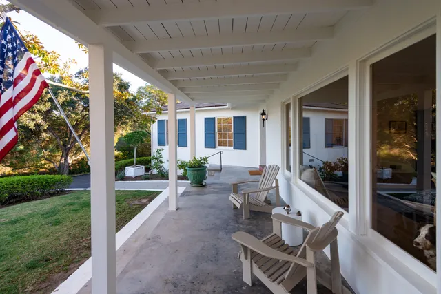 a view of an chairs and table in backyard of the house