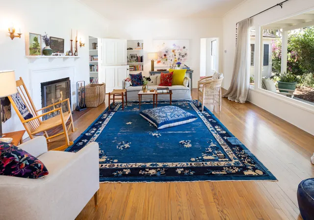 a bed sitting in a room next to a window