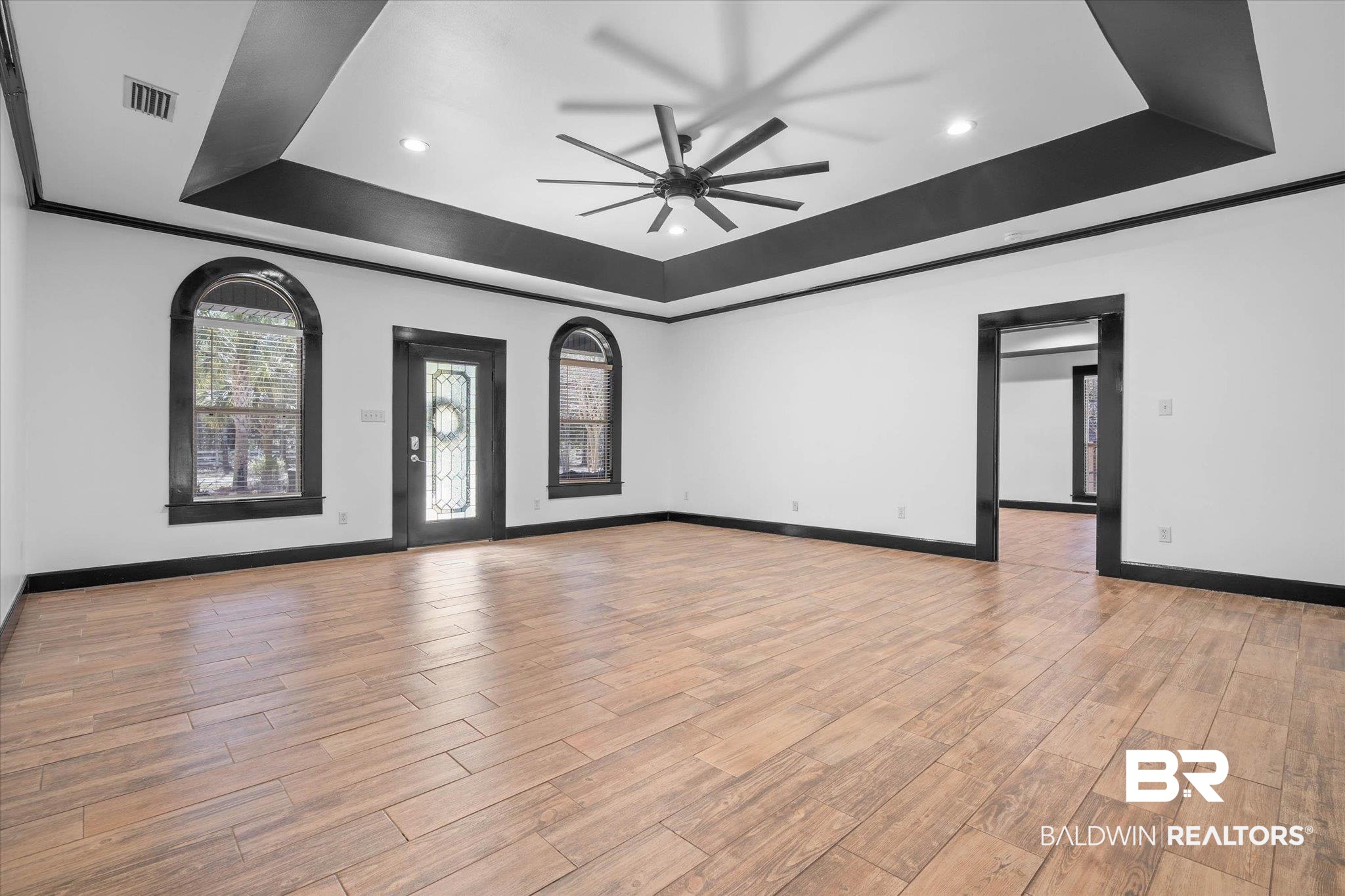 3216 Bay Booster Club Road Theodore, AL 36582 - Photo 3 of 46 Unfurnished living room with a tray ceiling, a ceiling fan, light wood-style floors, ornamental molding, and recessed lighting