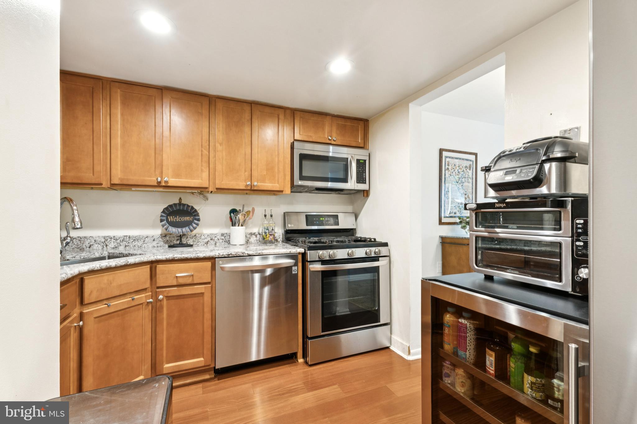 1413 Northgate Square, Unit 13/12B Reston, VA 20190 - Photo 11 of 25 a kitchen with granite countertop a stove top oven microwave and cabinets