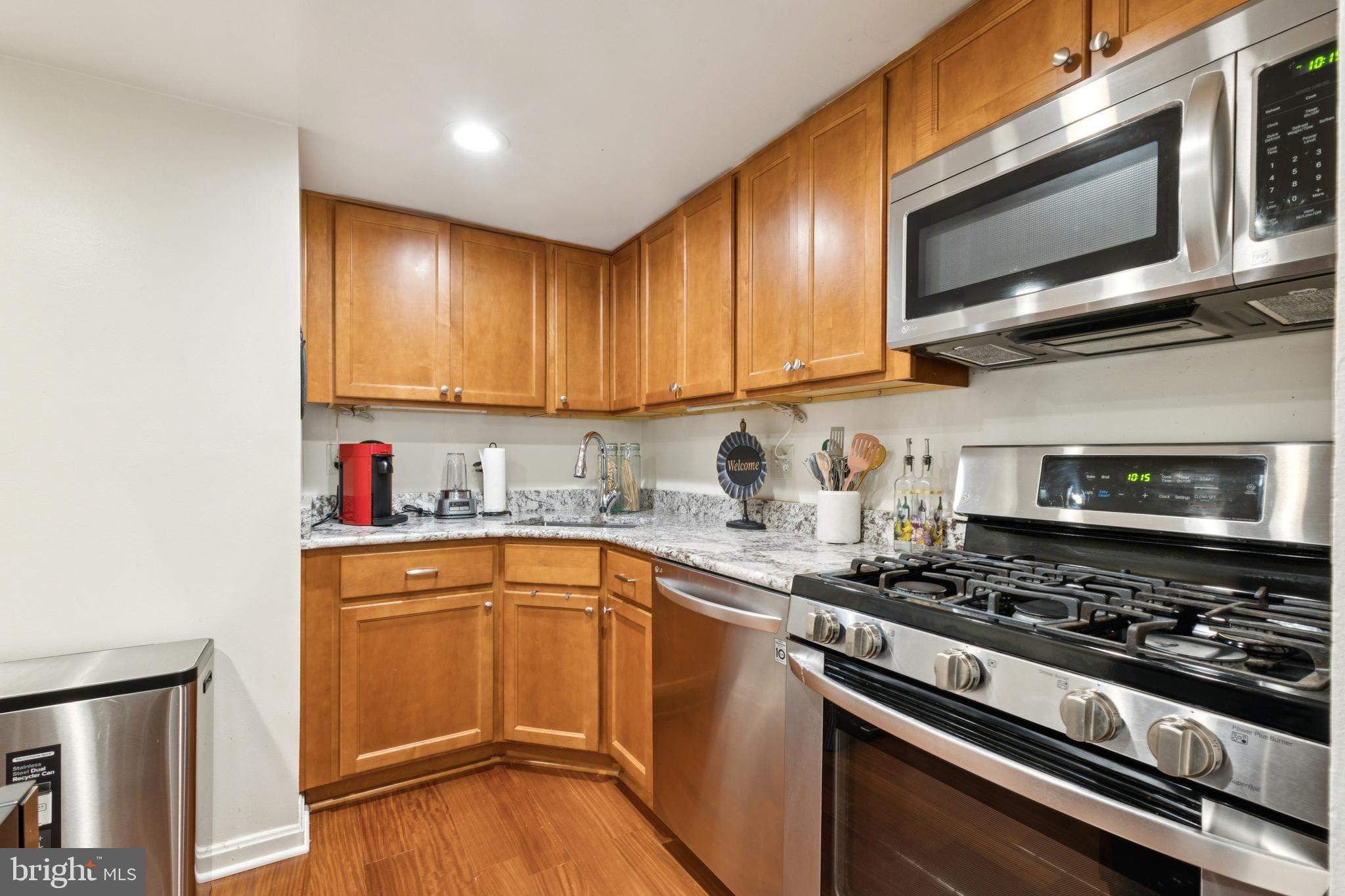 1413 Northgate Square, Unit 13/12B Reston, VA 20190 - Photo 12 of 25 a kitchen with stainless steel appliances granite countertop a stove microwave and sink