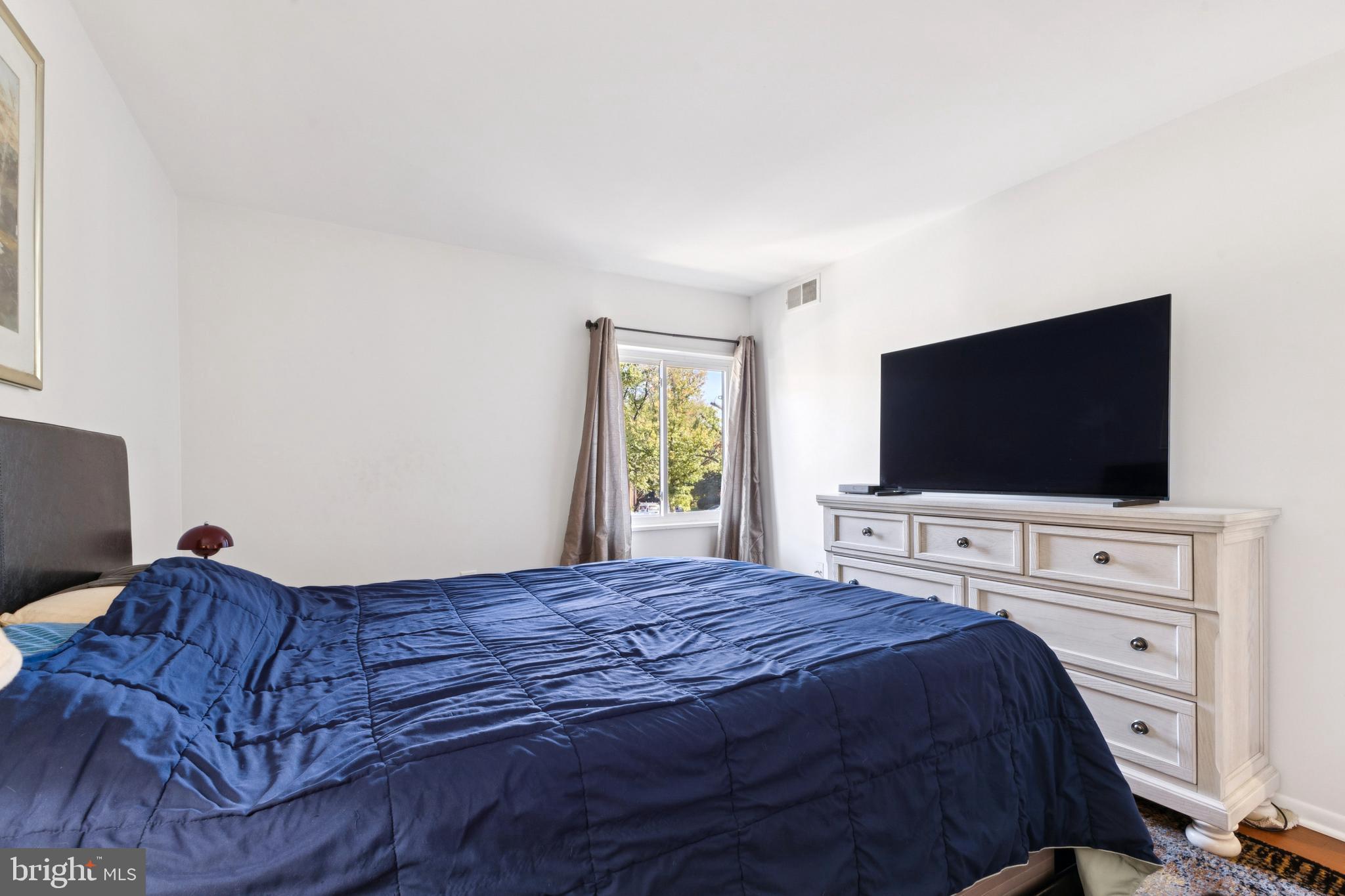 1413 Northgate Square, Unit 13/12B Reston, VA 20190 - Photo 15 of 25 a bedroom with a bed and a flat screen tv