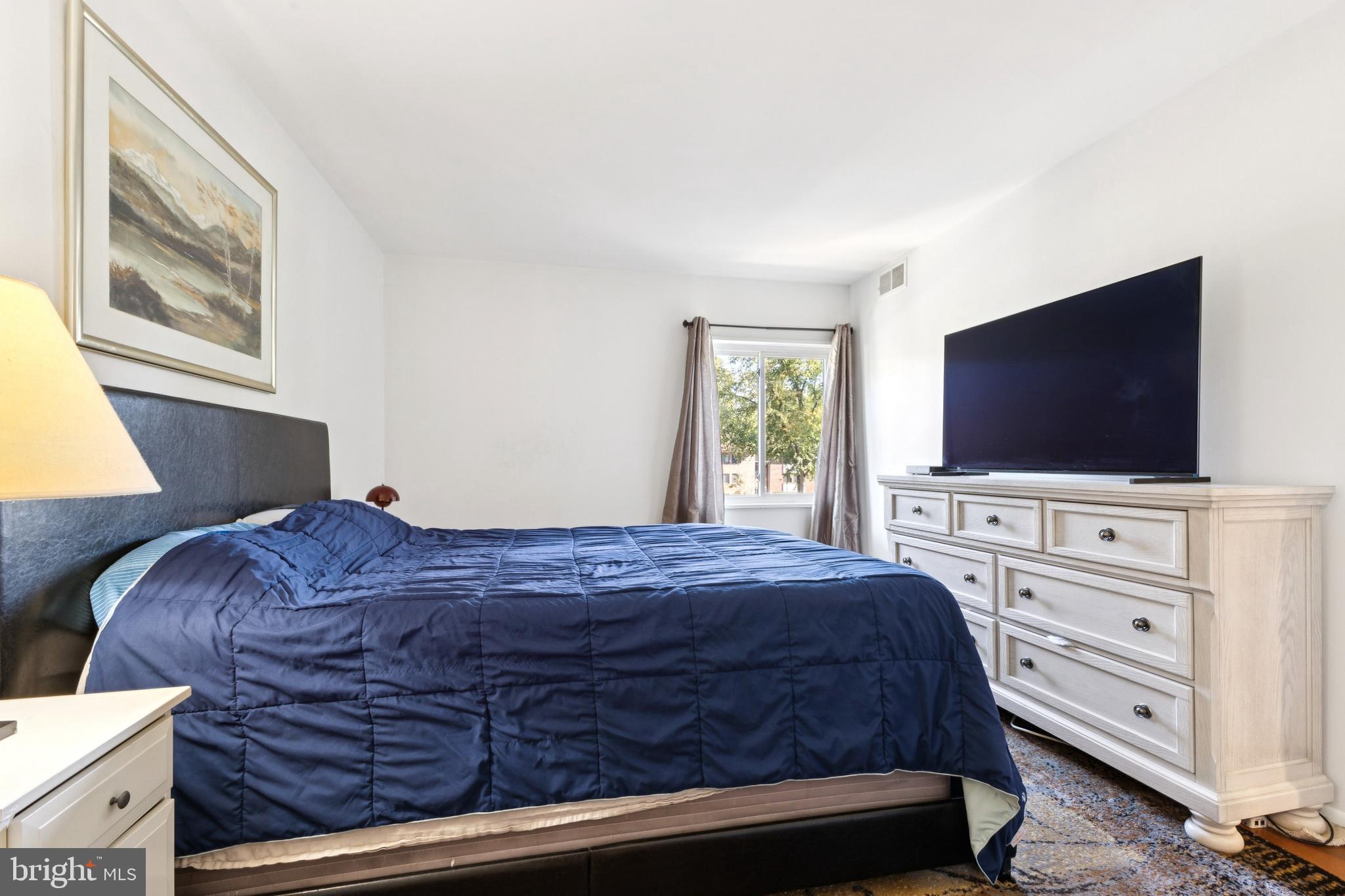 1413 Northgate Square, Unit 13/12B Reston, VA 20190 - Photo 16 of 25 a bedroom with a bed and a flat screen tv