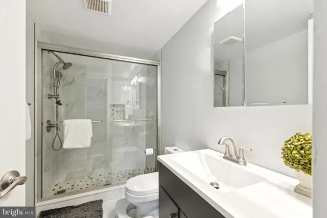 a bathroom with a sink toilet and shower