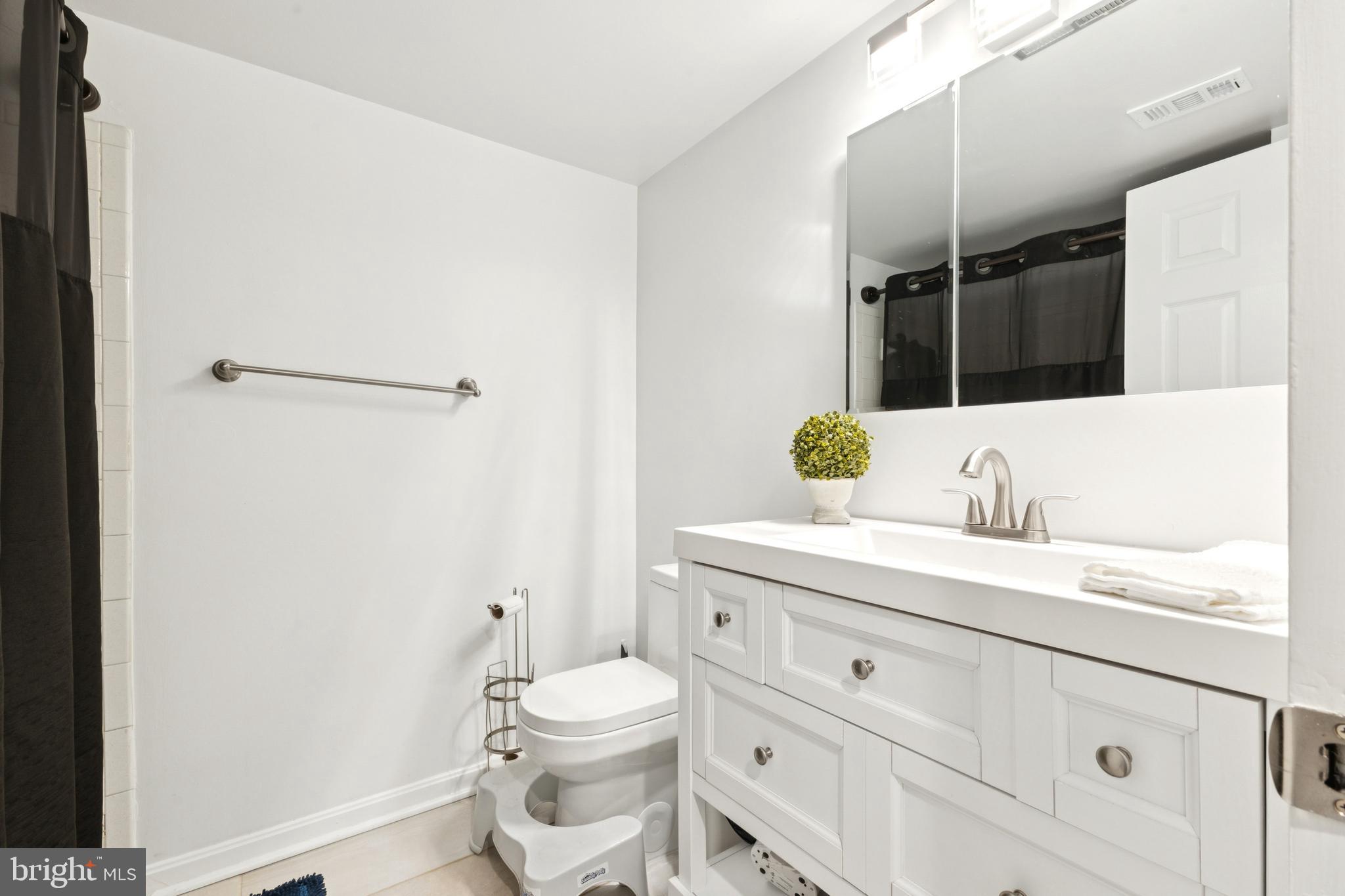 1413 Northgate Square, Unit 13/12B Reston, VA 20190 - Photo 23 of 25 a bathroom with a granite countertop sink vanity mirror and toilet