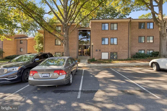 a car parked in front of a white house