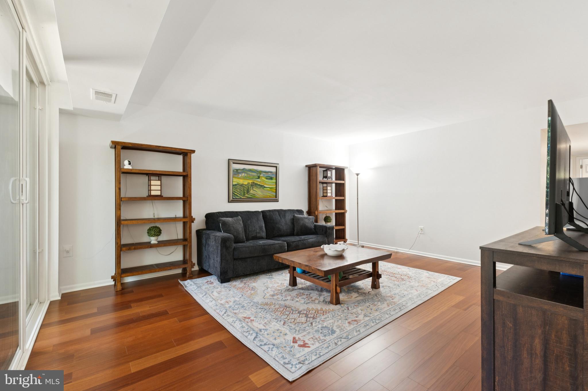 1413 Northgate Square, Unit 13/12B Reston, VA 20190 - Photo 4 of 25 a living room with furniture and a wooden floor