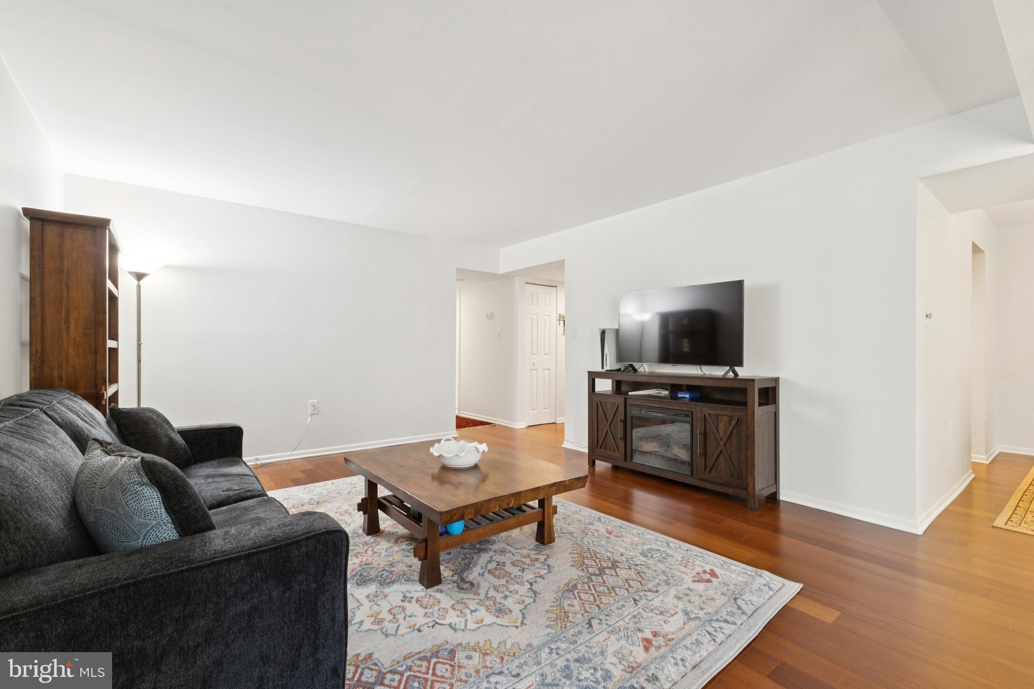 1413 Northgate Square, Unit 13/12B Reston, VA 20190 - Photo 6 of 25 a living room with furniture and a flat screen tv